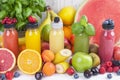 Many different fruits and berries and juices in plastic bottles. Watermelon, banana, applesin, blueberries, strawberries, basil. Royalty Free Stock Photo