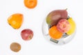 many different fruits on scales Royalty Free Stock Photo