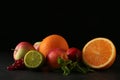 Many different fruits on table against black background Royalty Free Stock Photo