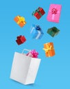 Many different gift boxes falling into paper shopping bag on light blue background Royalty Free Stock Photo