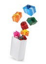 Many different gift boxes falling into paper shopping bag on white background Royalty Free Stock Photo
