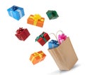 Many different gift boxes falling into paper shopping bag on white background Royalty Free Stock Photo