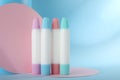 Many different glue sticks and paper cutouts on light blue background Royalty Free Stock Photo