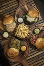 many different gourmet burgers selection on wood table