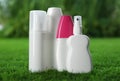 Many different insect repellents on green grass Royalty Free Stock Photo
