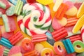 Many different jelly candies and lollipop as background, top view