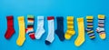 Many different mismatched baby kid socks on light blue background. Odd Socks Day, Lonely Sock Day, Anti-Bullying Week Royalty Free Stock Photo