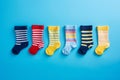 Many different mismatched baby kid socks on light blue background. Odd Socks Day, Lonely Sock Day, Anti-Bullying Week Royalty Free Stock Photo