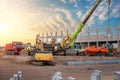 Many different multiclored colorful heavy industrial machinery equipment at construction site parking area against