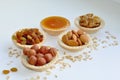 Many different nuts poured into tartlets with honey