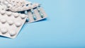 Many different packs of pills on a blue background. Banner with copyspace Royalty Free Stock Photo