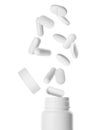 Many different pills falling into bottle on white background Royalty Free Stock Photo