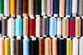 Many different reels with threads, flat lay, top view. Colored threads, close-up, bright background. Cutting and sewing clothes Royalty Free Stock Photo