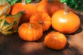 Many different ripe orange pumpkins on wooden table outdoors Royalty Free Stock Photo