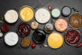 Many different sauces on black table, flat lay Royalty Free Stock Photo