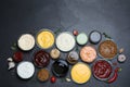 Many different sauces on black table, flat lay Royalty Free Stock Photo