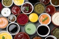 Many different sauces and herbs on black table, flat lay Royalty Free Stock Photo