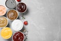 Many different sauces on light grey table, flat lay. Space for text Royalty Free Stock Photo