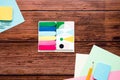 Many different school supplies, sheets of colored paper, pencil, paper clips on a wooden background. Flat lay. Royalty Free Stock Photo