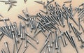 Many different screws on wooden table above each other Royalty Free Stock Photo