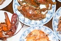 Many different seafood lobster shrimp octopus crabs dish lie on meze plates