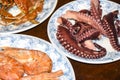 Many different seafood lobster shrimp octopus crabs dish lie on meze plates