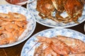 Many different seafood lobster shrimp octopus crabs dish lie on meze plates