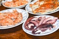 Many different seafood lobster shrimp octopus crabs dish lie on meze plates