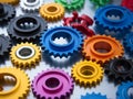 many different shapes of multi-colored parts on a black background, gears, round, teeth, hubs, mechanisms