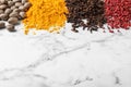 Many different spices on marble background. Space for text Royalty Free Stock Photo