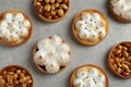 Many different tartlets on grey table, flat lay. Delicious dessert