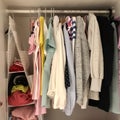 many different things hang and lie in the closet in the wardrobe.