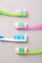 Many different toothbrushes on light background, flat lay