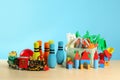 Many different toys on wooden table against blue background