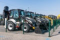 Many different tractors standing in row at agricultural fair for sale outdoors. Equipment for agriculture.