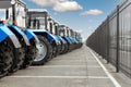 Many different tractors standing in row at agricultural fair for sale outdoors.Equipment for agriculture.Heavy