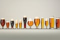 Many different types of beer in glass on grey background with copy space, series of beer glasses in various shapes and sizes,