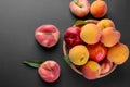 Many different varieties of peaches in a wicker basket on a black background. Royalty Free Stock Photo