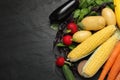 Many different vegetables on black table, flat lay. Space for text Royalty Free Stock Photo