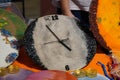 Many different wall clock displayed for sale. Round frame orange and gray colored clocks. Eccentric luxurious vintage antique