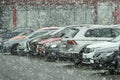 Many differents cars are parking during heavy snowing in winter season. Royalty Free Stock Photo