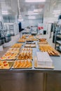 Many dishes prepared on the metal table of a food factory