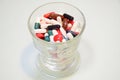 Many drug and pill fill in the glass on light background. Royalty Free Stock Photo