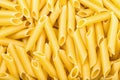 Many durum wheat semolina pasta penne lisce Royalty Free Stock Photo