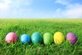 Many Easter eggs, many colors, are placed on the grass.