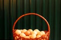 Many eggs in basket. Closeup whole basket of brown organic eggs on green modern background. Poultry farm. Eco Royalty Free Stock Photo