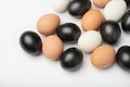 Many eggs of different colors on white background. Black, white and brown eggs. Royalty Free Stock Photo