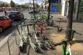 Many Electric E-Scooters of different Ride Sharing Companies parked chaotically on a sidewalk in Berlin close to the Brandenberg