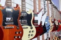 Many electric guitars hanging on wall