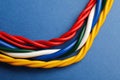 Many electrical cables on blue background, closeup Royalty Free Stock Photo